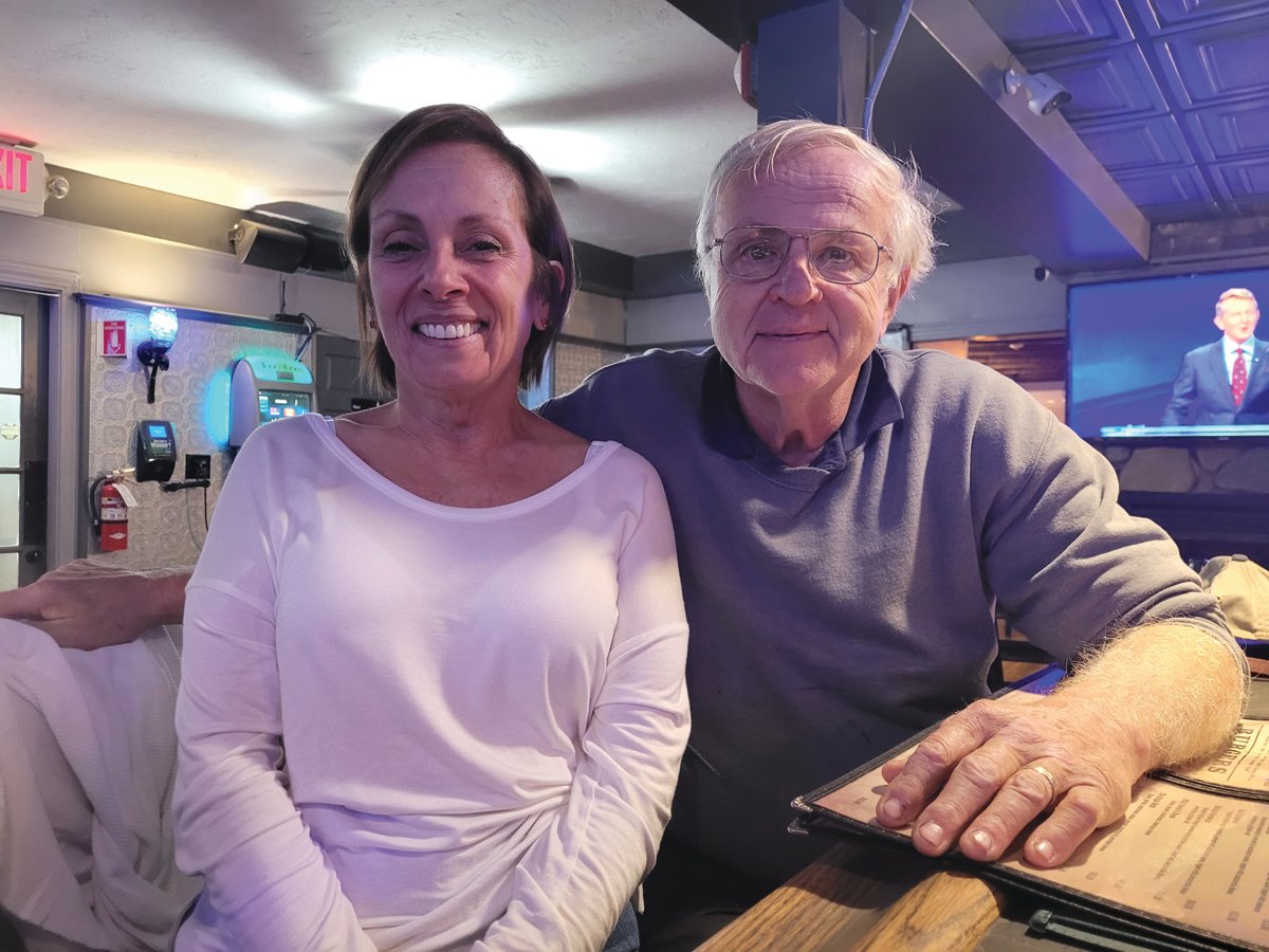 BURGER & A BEER: Karen E. Cappelli Chadwick, and her husband Tom, await election results while eating a burger and a beer at the Bishop Hill Tavern, 2868 Hartford Ave., in Johnston’s west-end.